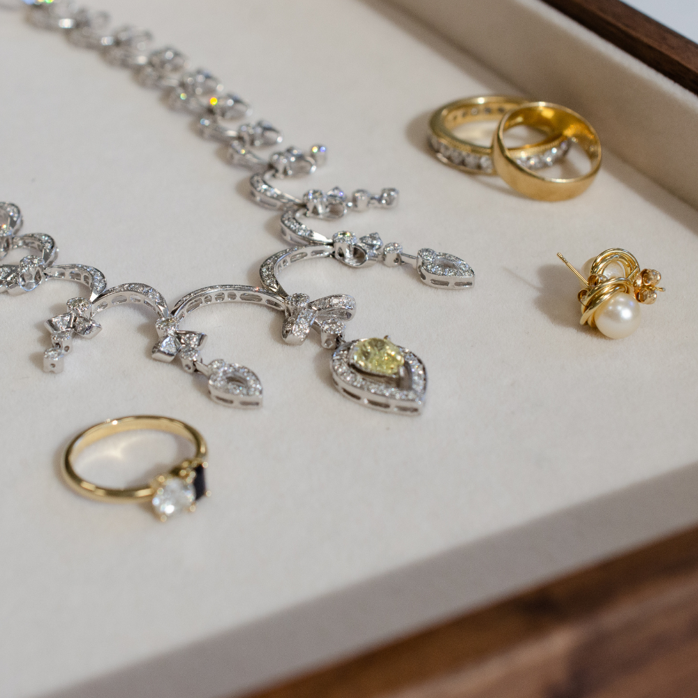 Image of ornate detail, white gold, diamond encrusted necklace, with vintage, yellow gold jewelry