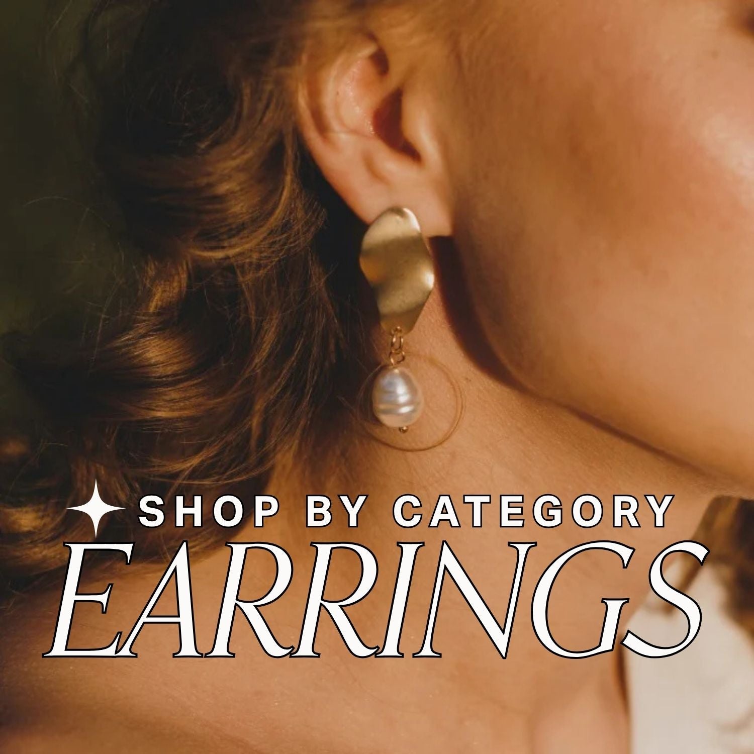 Close-up of a person wearing gold and pearl earrings with a blurred background, text overlay reads: shop by category: earrings