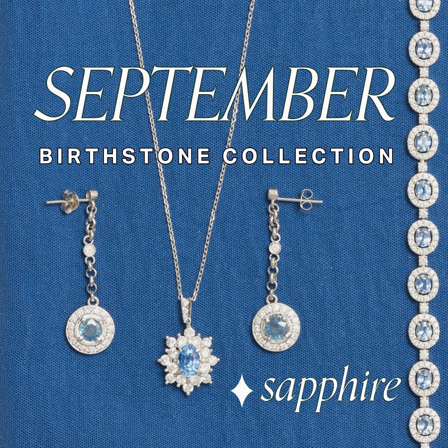 Jewelry display on cream and wood jewellery tray over cobalt blue linen fabric. Assorted fine gold jewellery features a range of blue sapphire gemstone jewellery pieces with text overlay: September Birthstone Collection, sapphire