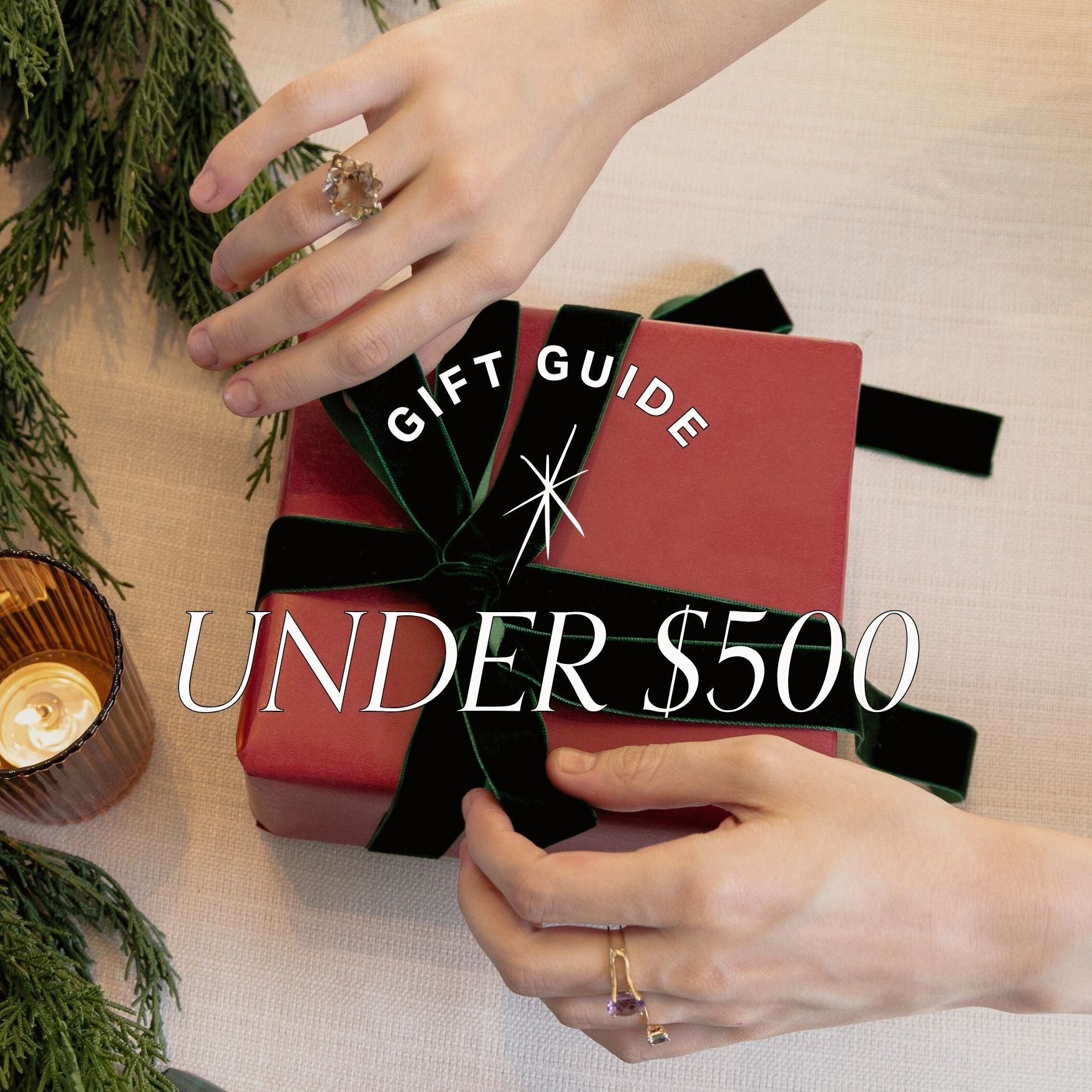 Gifts by price under $500 with hands holding a wrapped gift