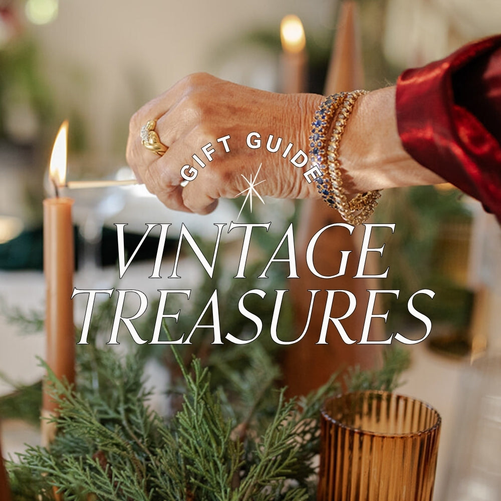 title text reads 'gift guide vintage treasures' displayed over image of woman lighting a candle wearing vintage gemstone bracelets at a holiday table