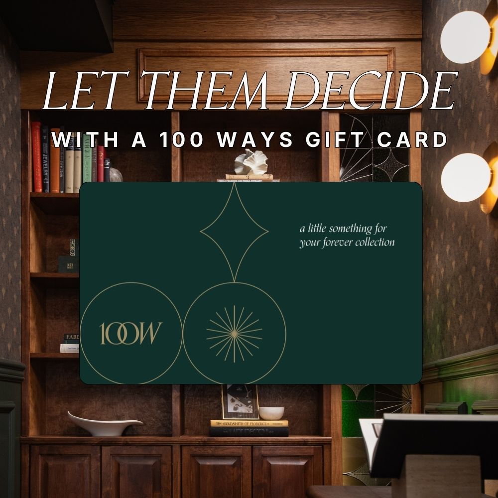 100 Ways jewellery gift card displayed in an elegant evergreen design with gold accents, set against a warm luxury boutique interior