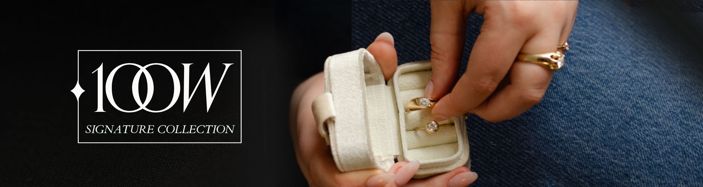 woman wearing jeans and black long sleeve shown holding small jewellery box with modern gold rings and brilliant diamonds made from reclaimed materials; text overlay reads 100W Signature Collection