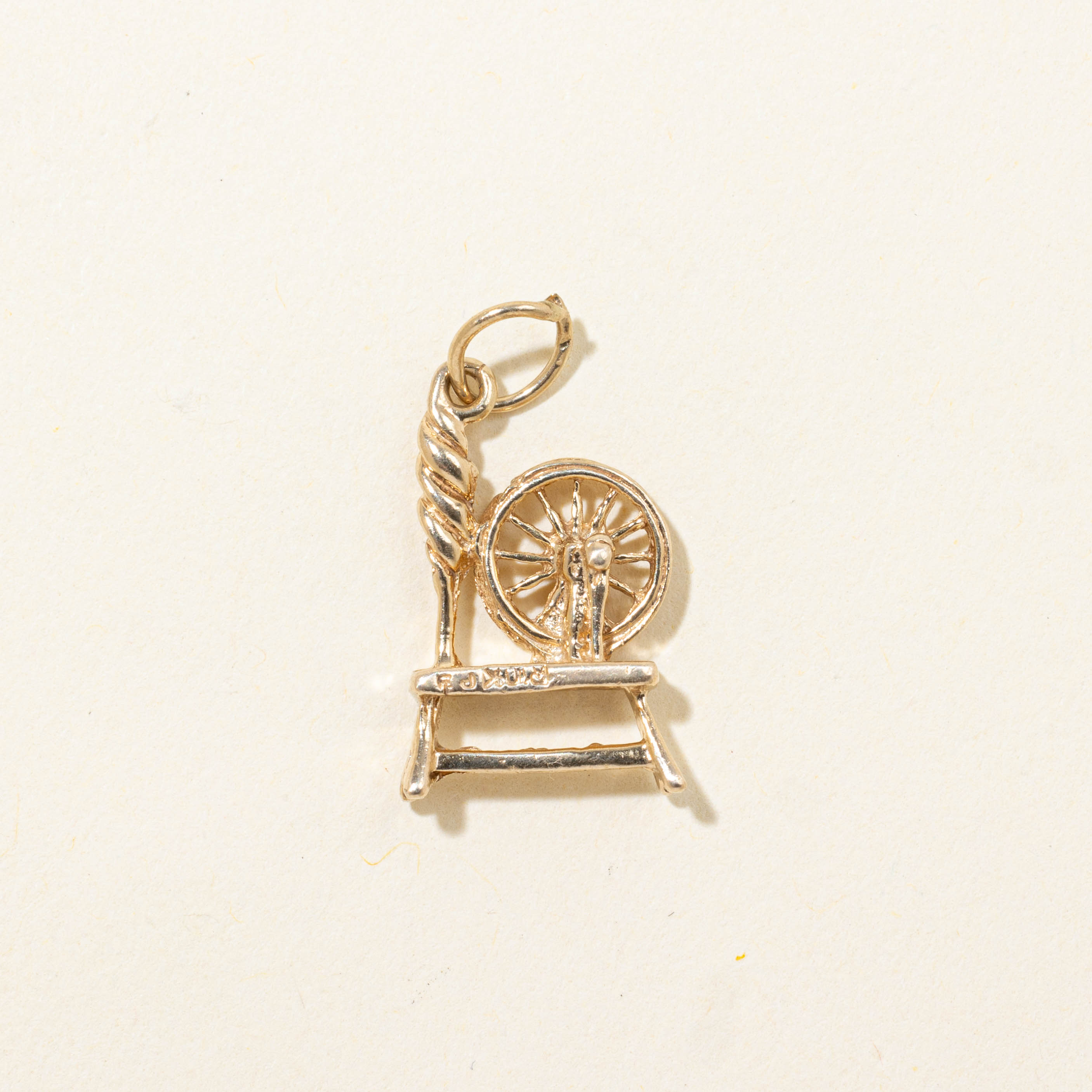 10k Spinning Wheel Charm