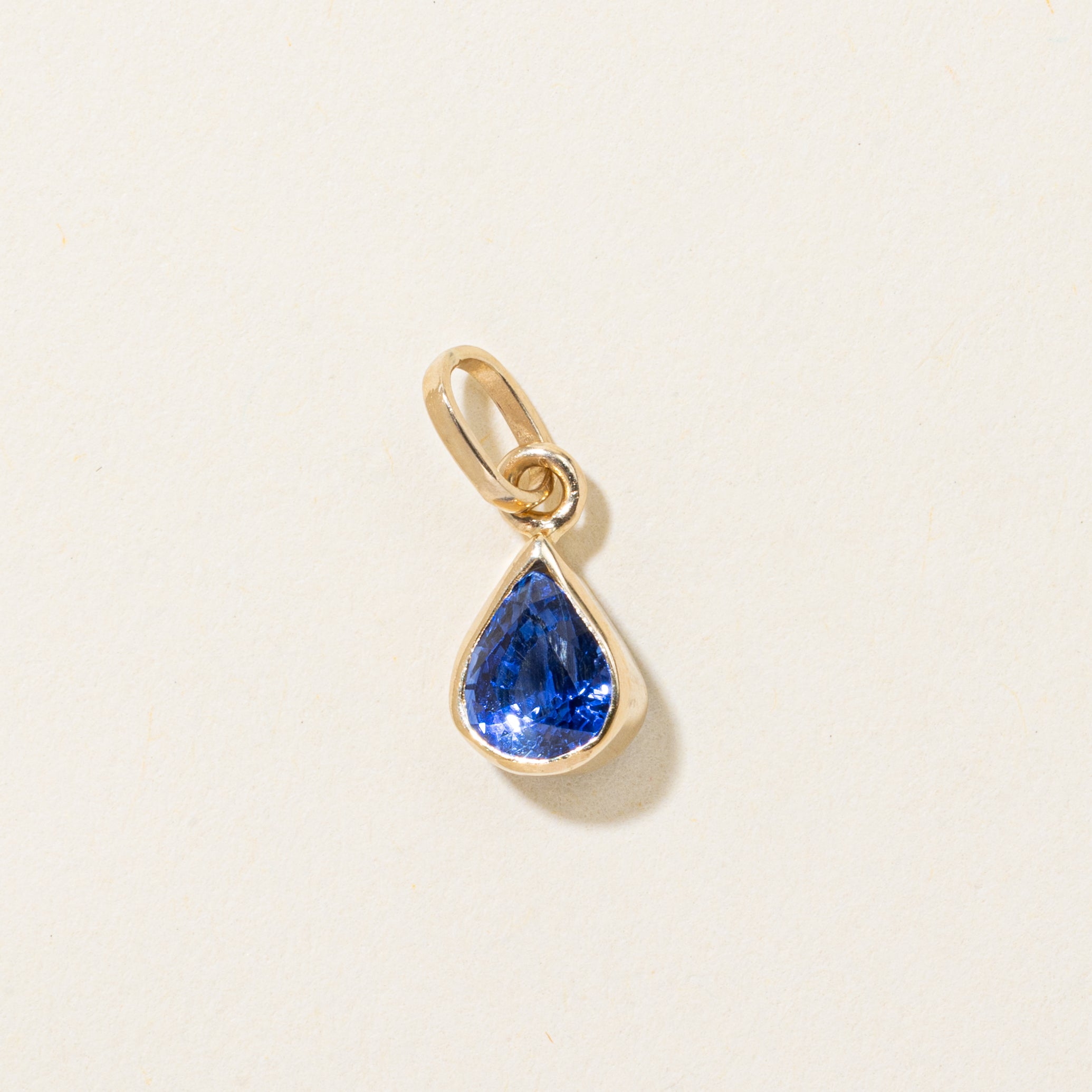 17k Bezel Set Pear Cut Synthetic Sapphire Pendant | 1.35ct