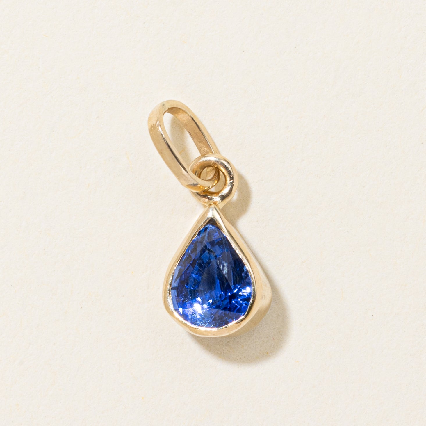 17k Bezel Set Pear Cut Synthetic Sapphire Pendant | 1.35ct