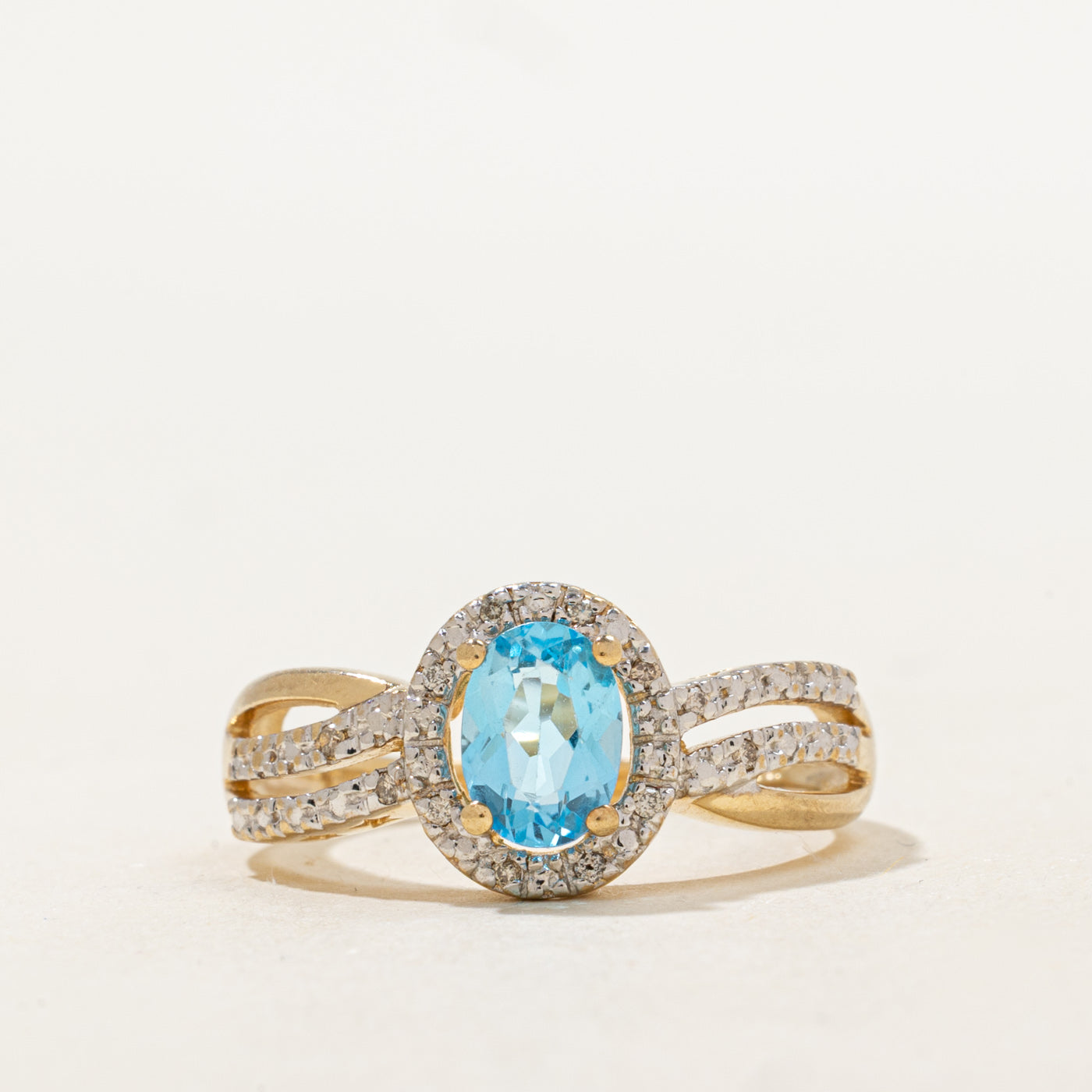 Oval Cut Blue Topaz & Diamond Halo Crossover Ring | 0.73ct, 0.06ctw | SZ 7.25 |