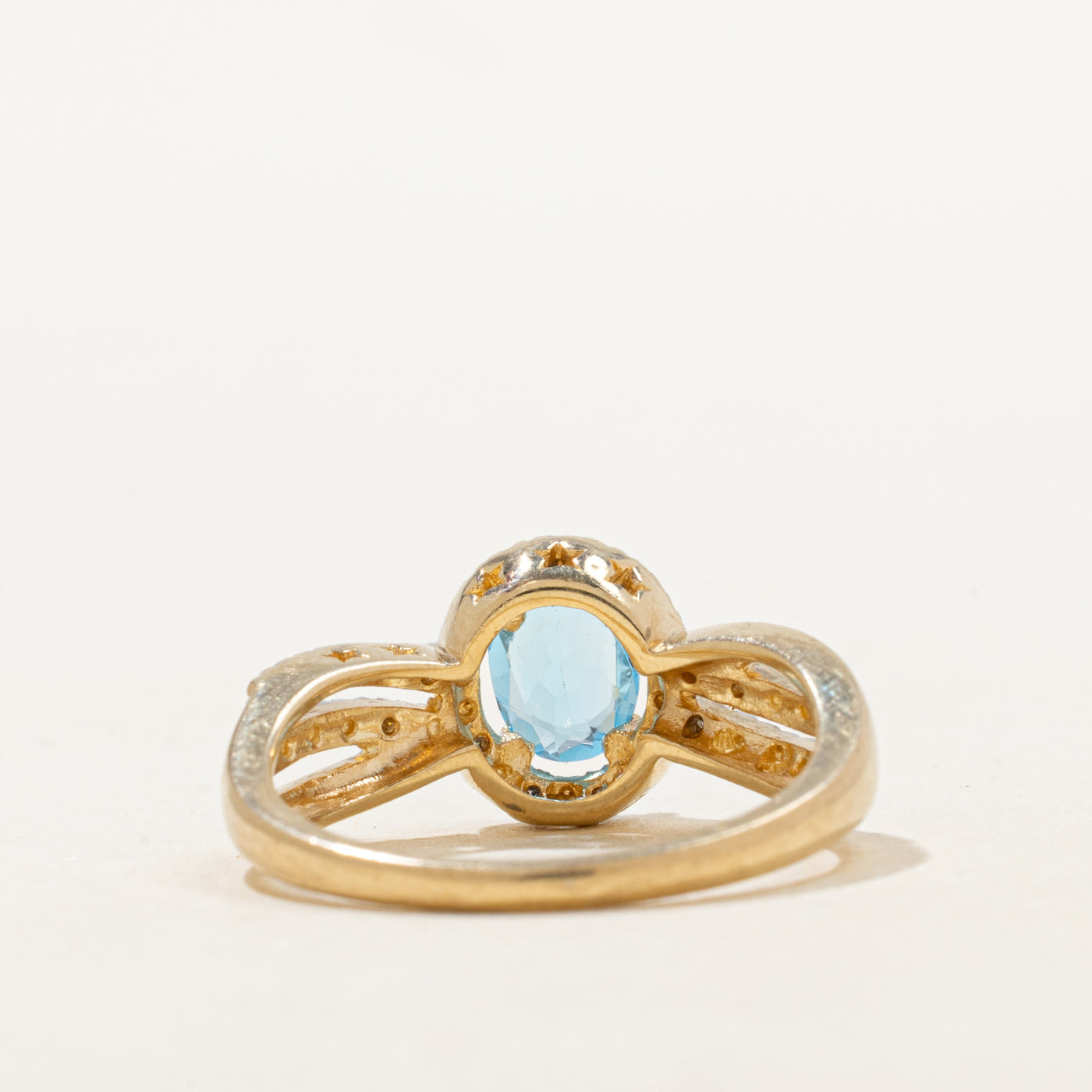 Oval Cut Blue Topaz & Diamond Halo Crossover Ring | 0.73ct, 0.06ctw | SZ 7.25 |