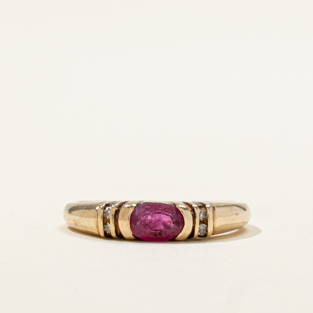 10k East West Oval Cut Ruby & Diamond Accented Ring | 0.50ct, 0.02ctw | SZ 6.75