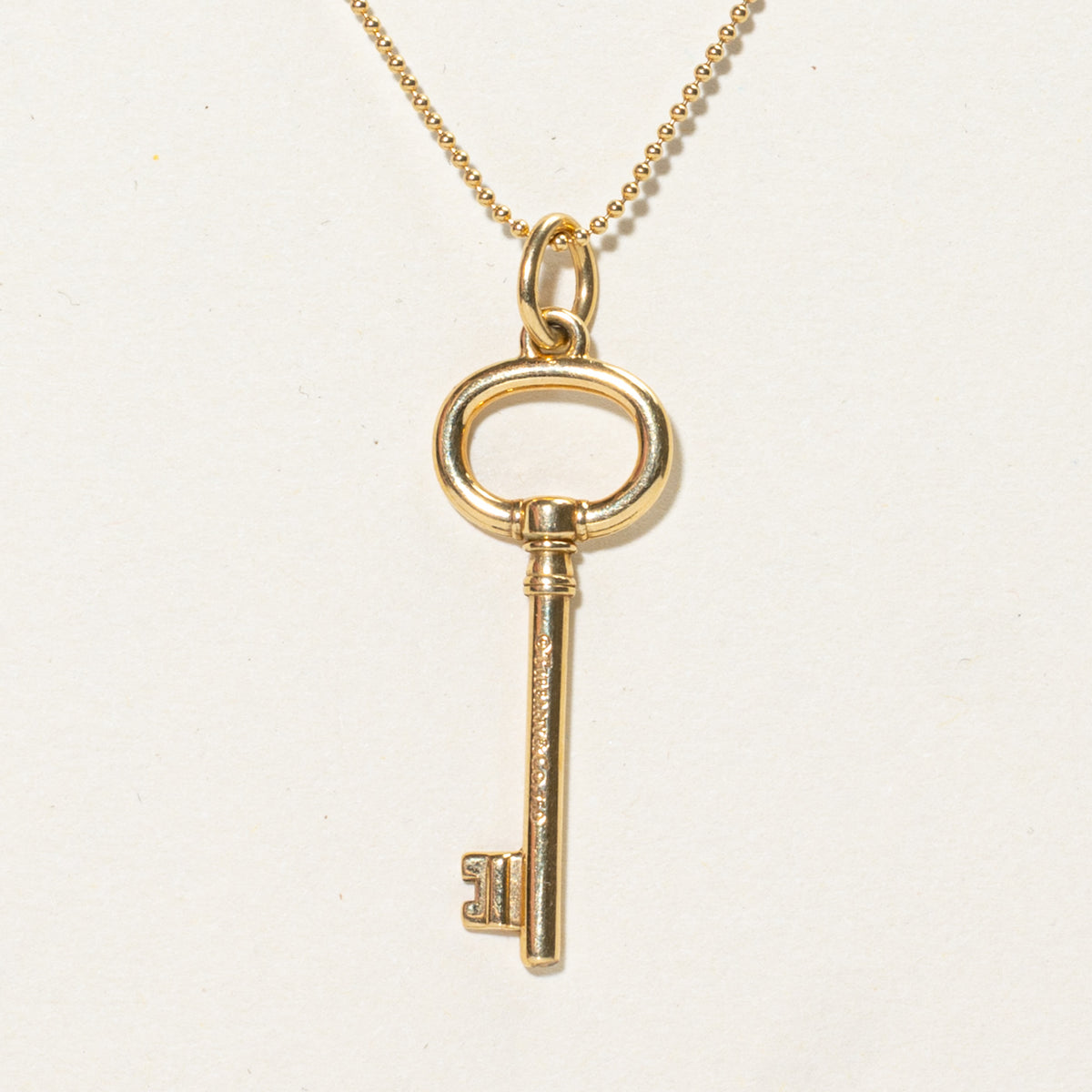'Tiffany & Co.' Yellow Gold Oval Key Charm Necklace | 24"
