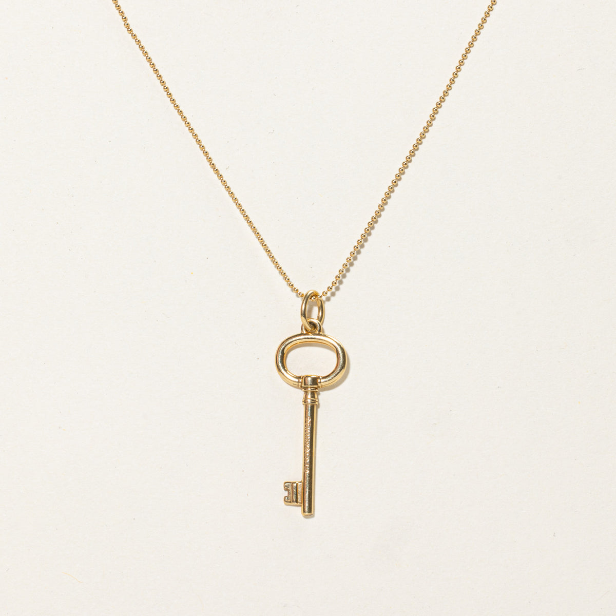 'Tiffany & Co.' Yellow Gold Oval Key Charm Necklace | 24"