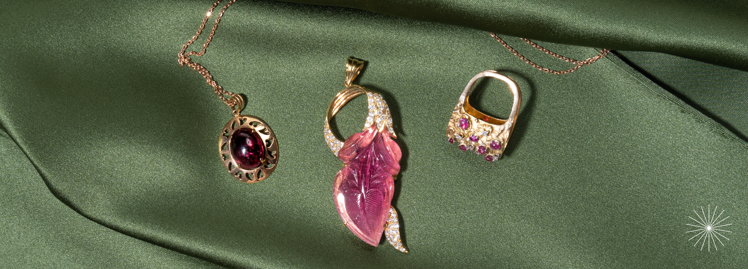 Image of tourmaline, october birthstone preloved jewellery pieces styled on olive green satin fabric