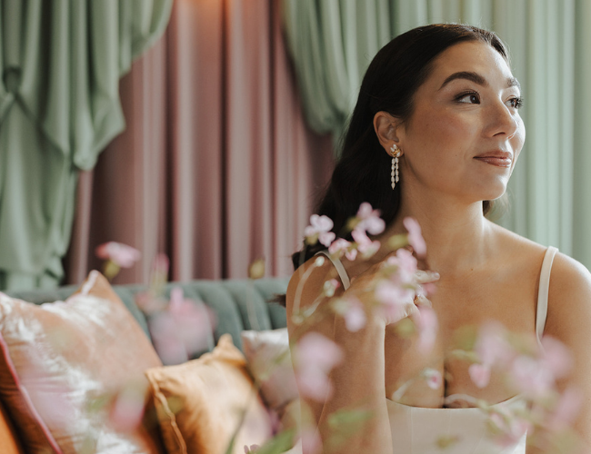 Modern bride wearing vintage pearl drop earrings styled in soft natural light, bridal jewellery style