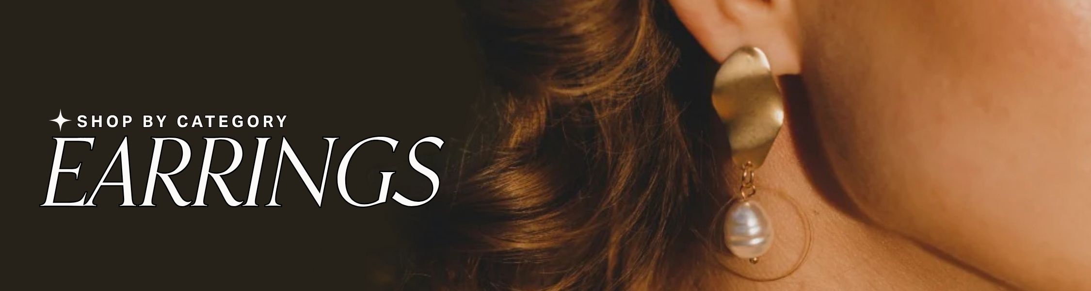 Close-up of a person wearing gold and pearl earrings with a blurred background, text overlay reads: shop by category: earrings