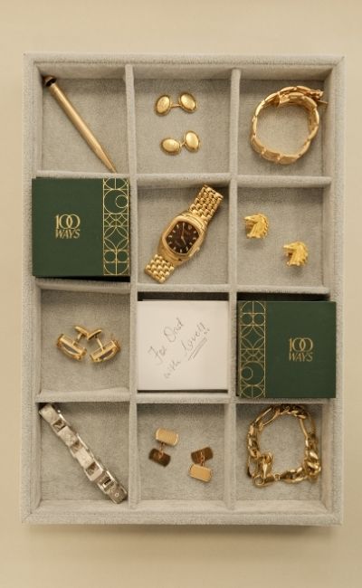 Collection of vintage, fine gold jewellery, cufflinks, and accessories displayed in a tray.
