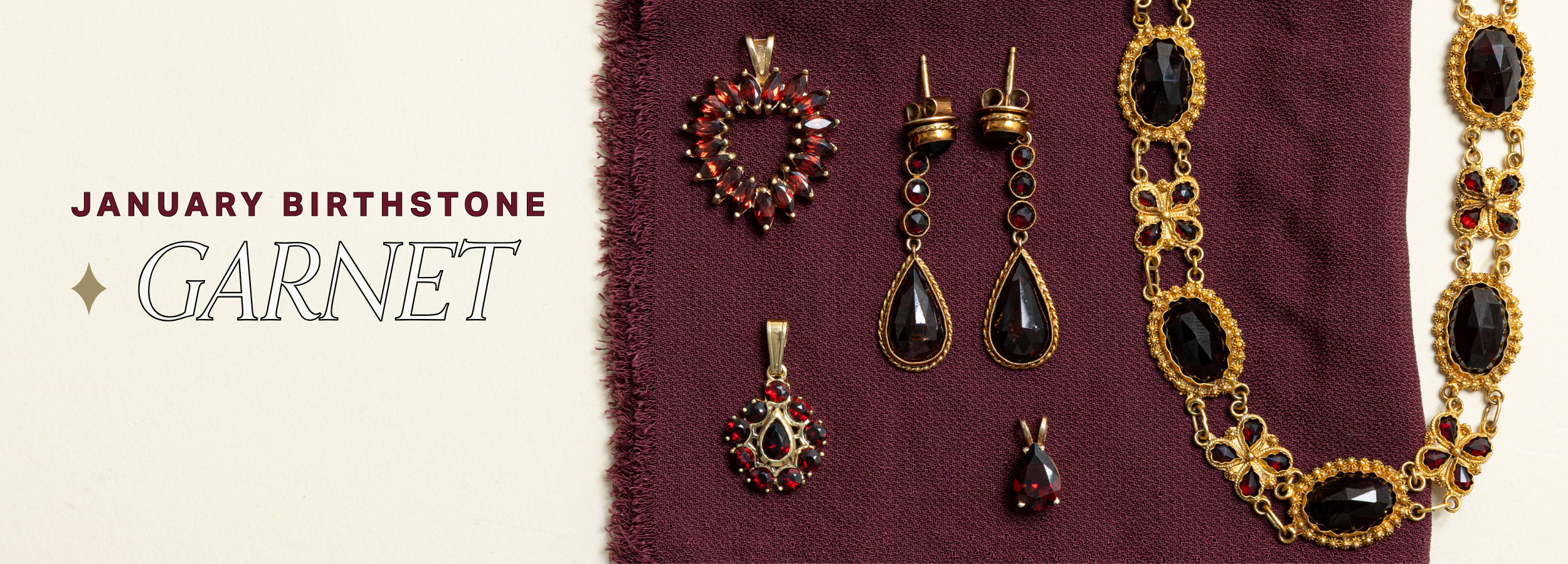 January birthstone garnet jewellery featuring vintage gold necklaces, earrings, and pendants with deep red garnet gemstones on a burgundy fabric background.