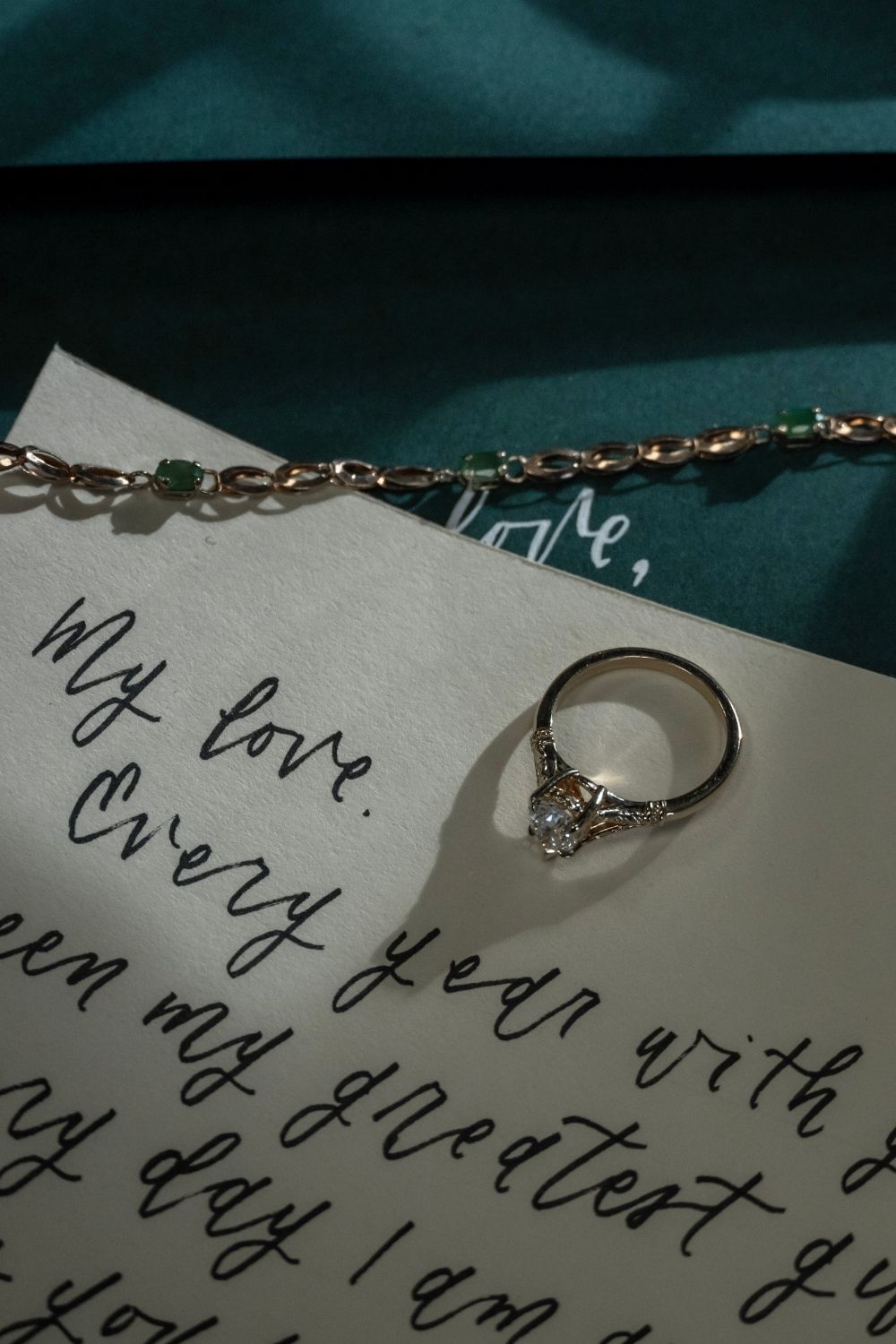 Vintage diamond engagement ring resting on a handwritten love letter, styled for a romantic Valentine’s Day.