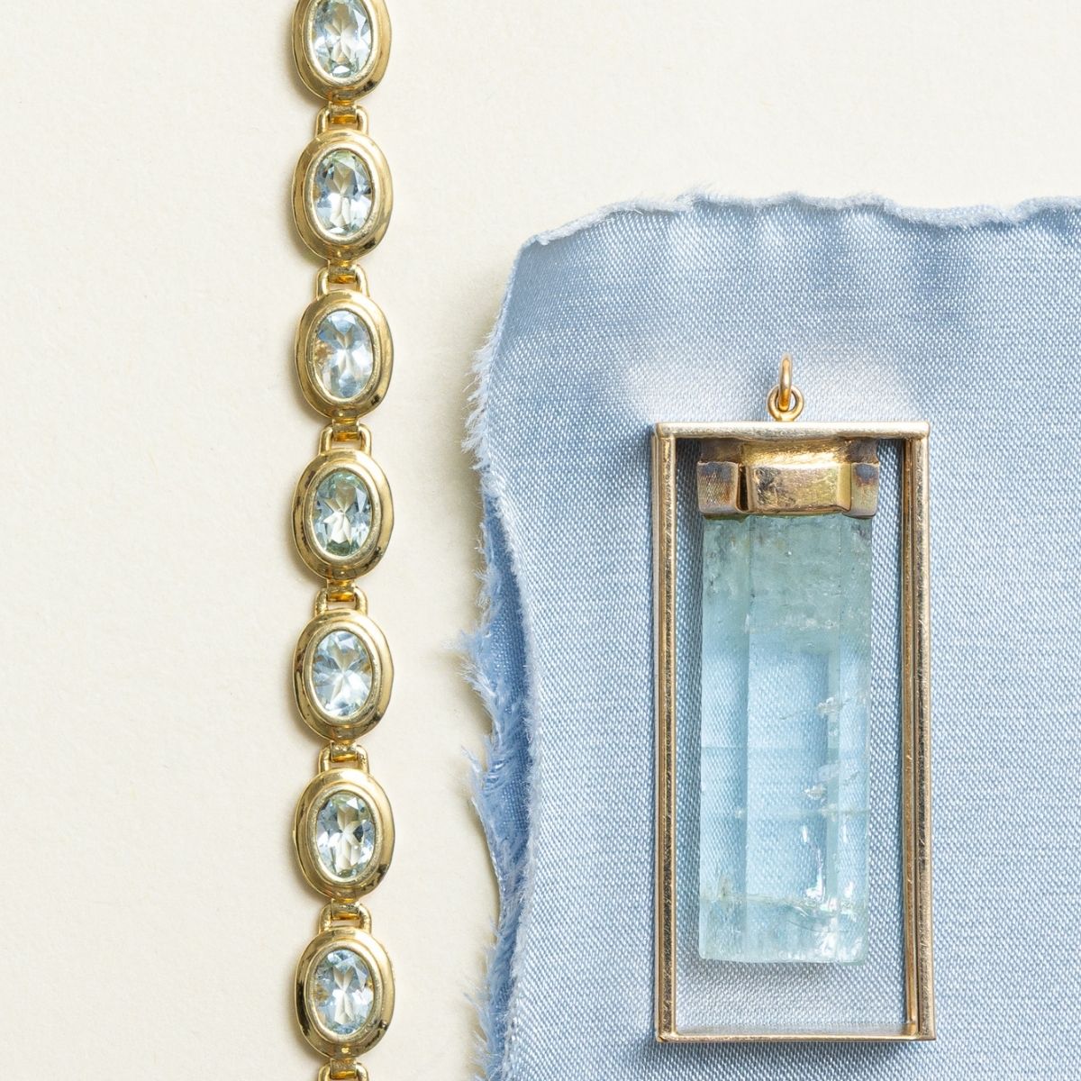 Oval cut aquamarine yellow gold bracelet, styled with large, aquamarine crystal pendant for March birthstones.