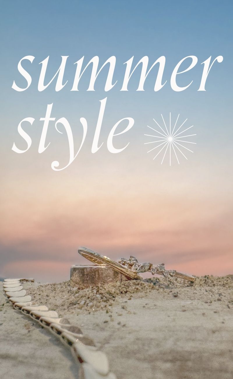 Cotton candy sunset skies backdrop with vintage, second hand rings and bracelet styled on the sand. Text reads: Summer style