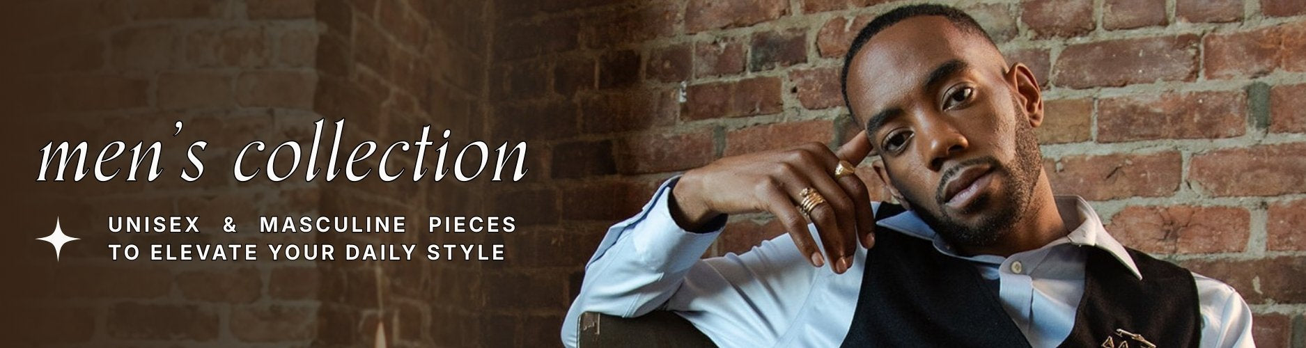 Man leaning against a brick wall wearing a vest over button down and unique vintage gold jewellery. Text overlay reads: men's collection: unisex & masculine pieces to elevate your daily style