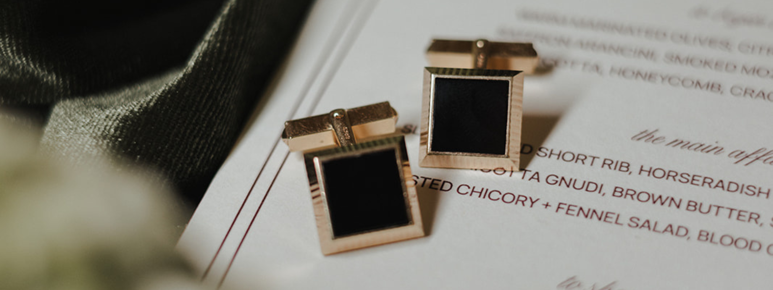 Vintage, gold square black onyx cufflinks on a menu with an olive green velvet background