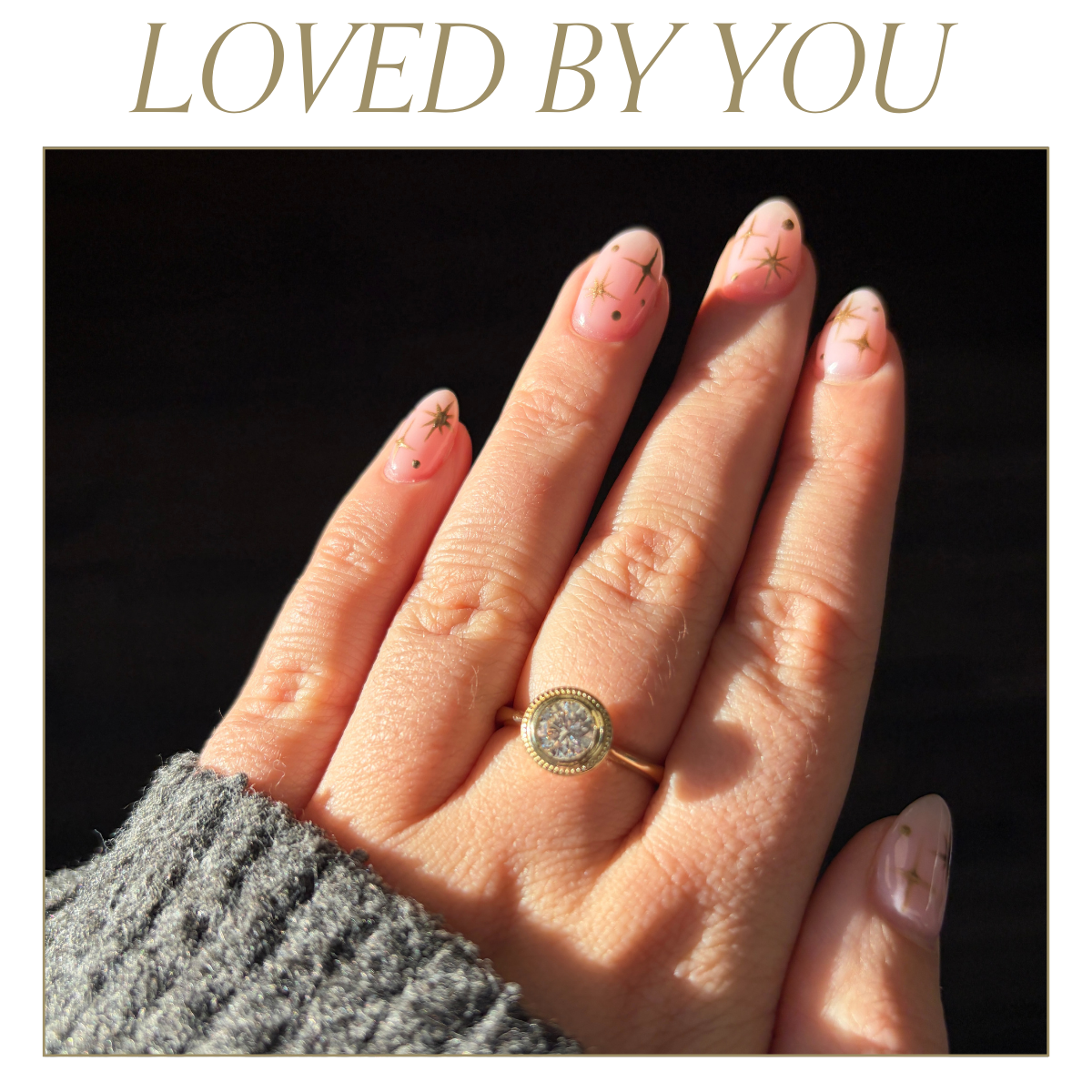 Vintage diamond ring worn on hand with gold star manicure, highlighting timeless fine jewellery design. Text reads: Loved by you