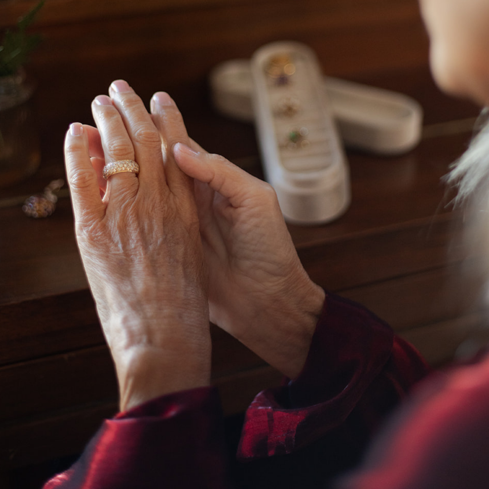 Close up of woman wearing a vintage diamond pave band, with elongated jewellery box in the foreground