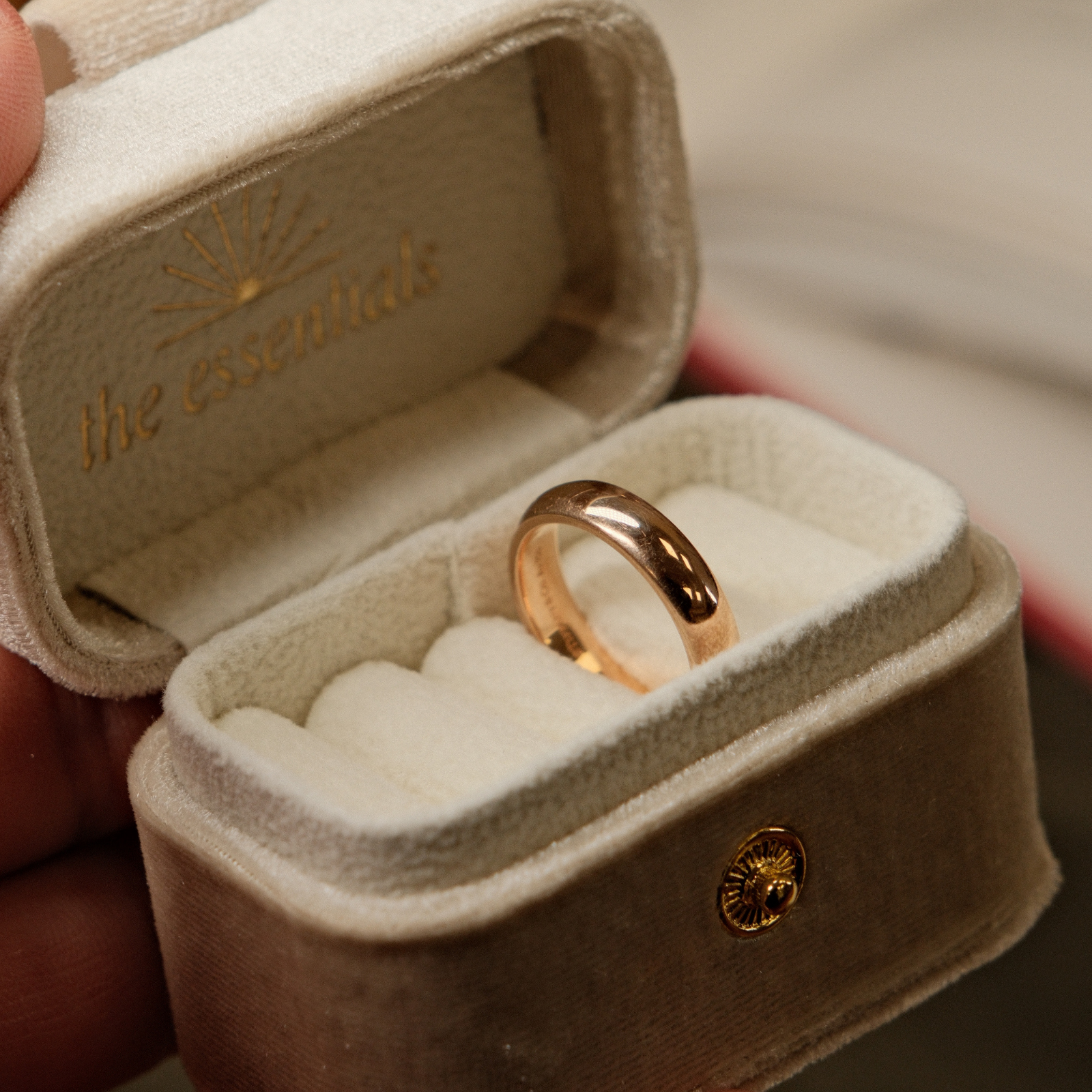 Classic preowned plain yellow gold wedding band resting inside a soft beige velvet ring box.