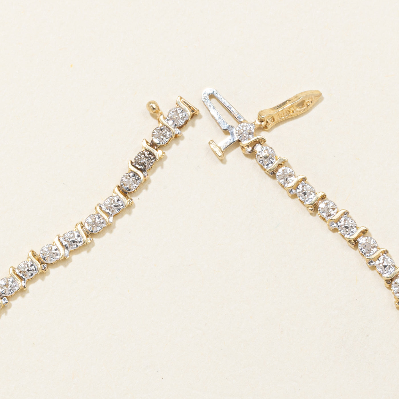 10K Yellow Gold Illusion Set Diamond Swirl Tennis Bracelet | 0.10ctw | 7"