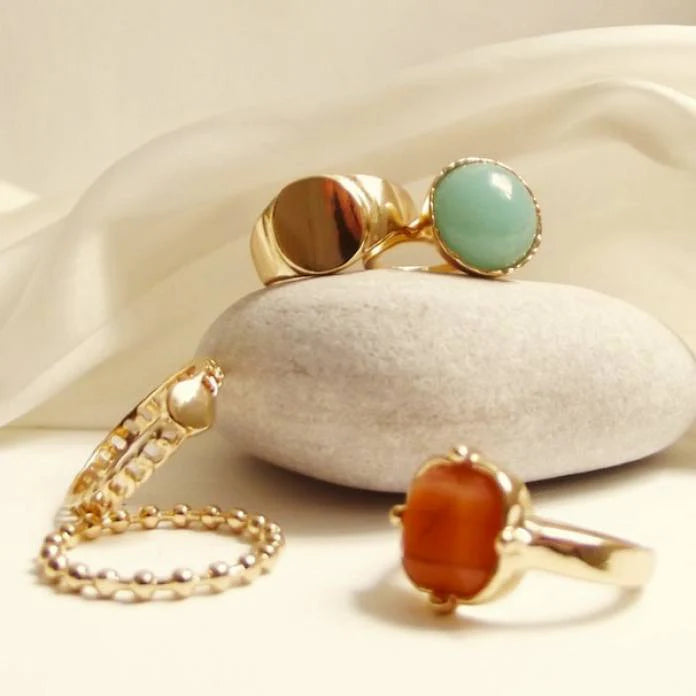 image features several rings including colourful gemstones