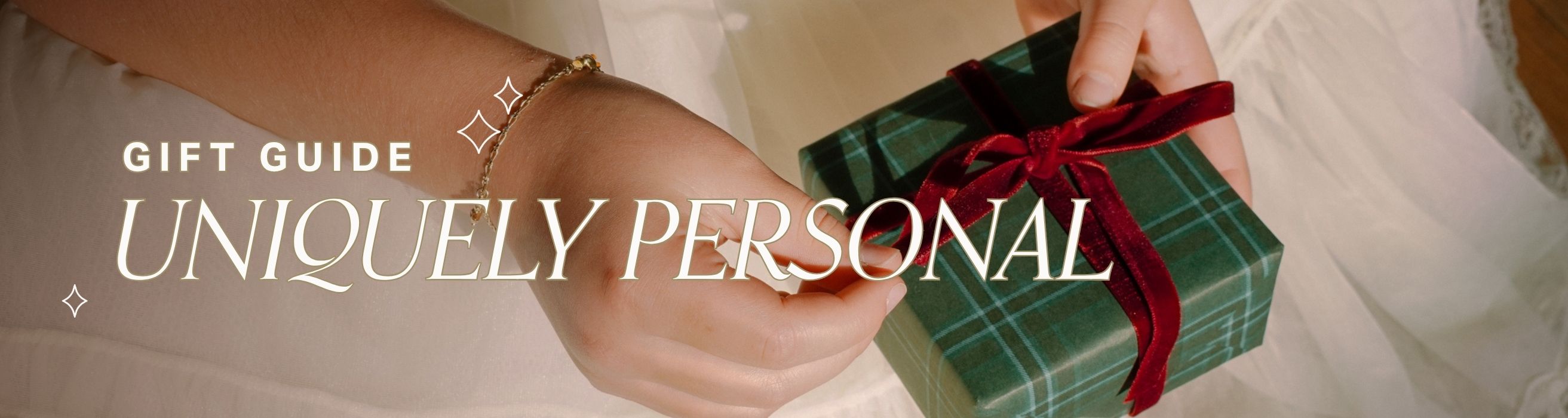 Person holding a green plaid gift box with a red ribbon, text 'Gift Guide: Uniquely Personal' above.