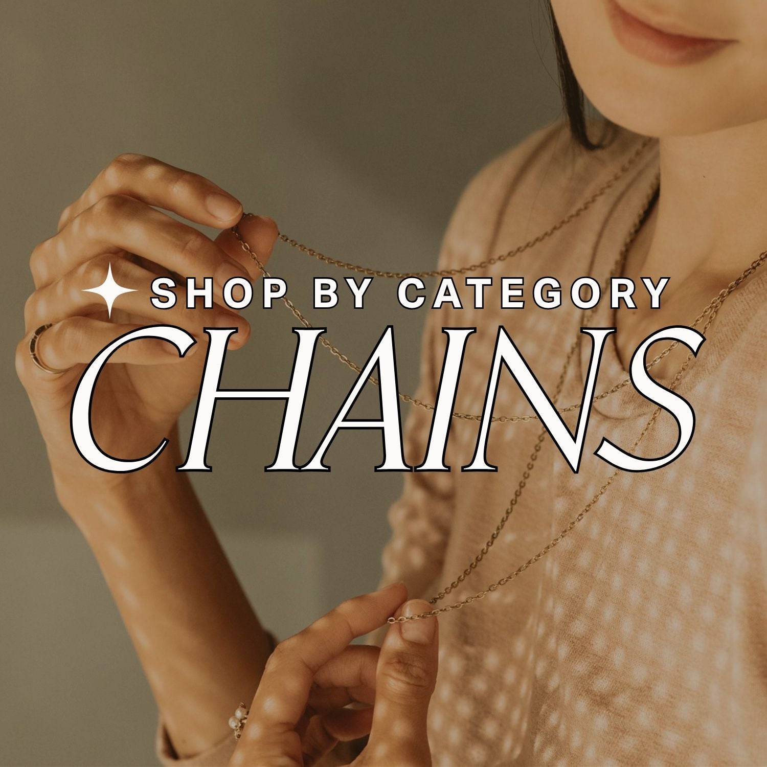 Hand holding a gold chain with 'Shop by Category: Chains' text overlay on a beige background