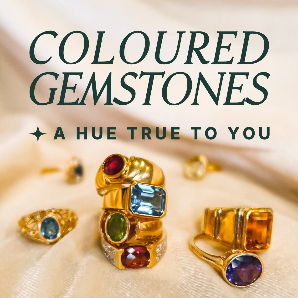 Gold rings with brightly colored gemstones on a beige fabric background, text overlay reads: coloured gemstones, a hue true to you
