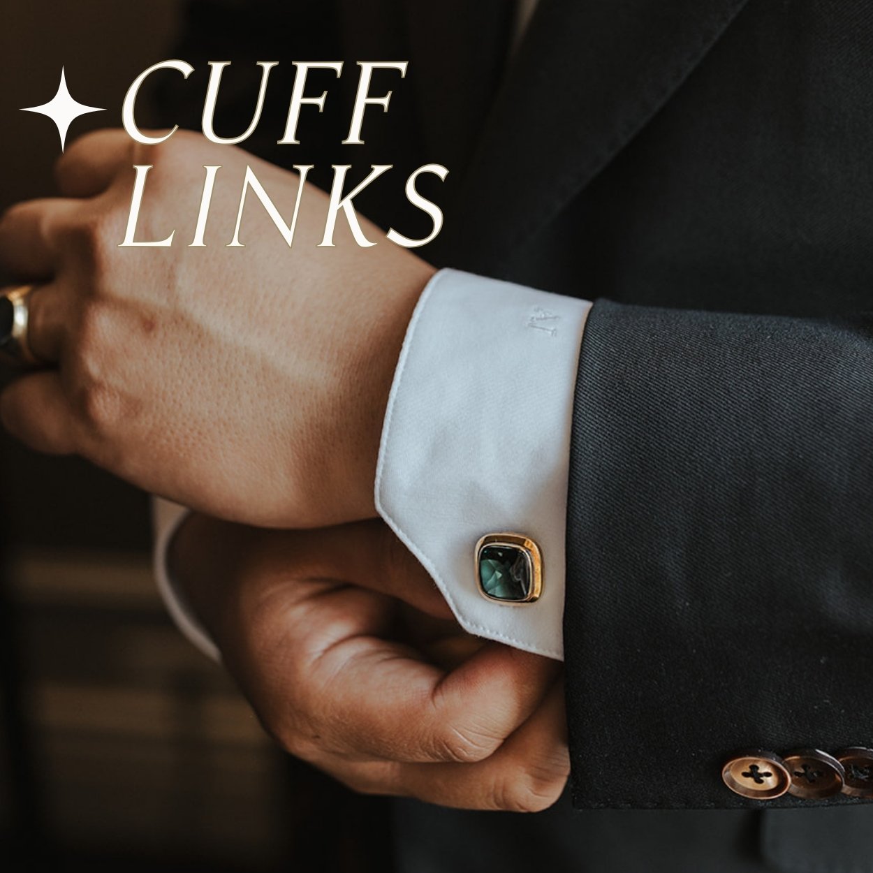 Close-up of a square aquamarine bezel gold cuff link on a suit cuff with text  overlay 'CUFF LINKS'