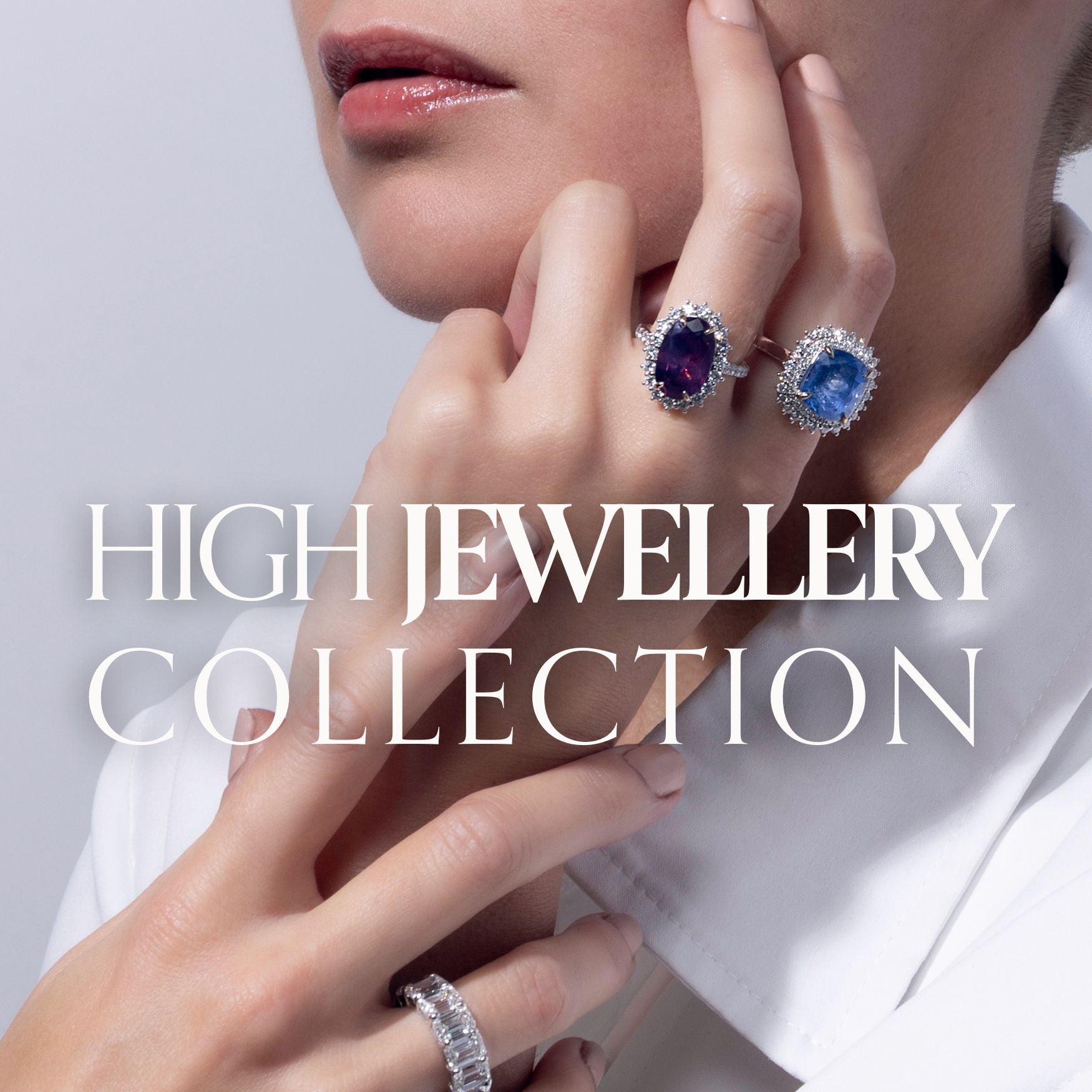 image of woman wearing large gemstone rings with halo setting of diamonds and plain white collared shirt. title text reads: high jewellery collection
