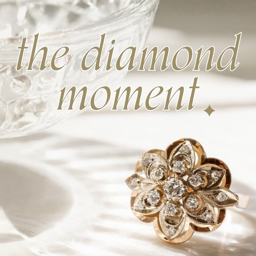 close up image of diamond ring in yellow gold floral setting, on shadowy white background with text overlay that reads 'the diamond moment; a selection of diamond jewellery pieces marked down for a limited time'