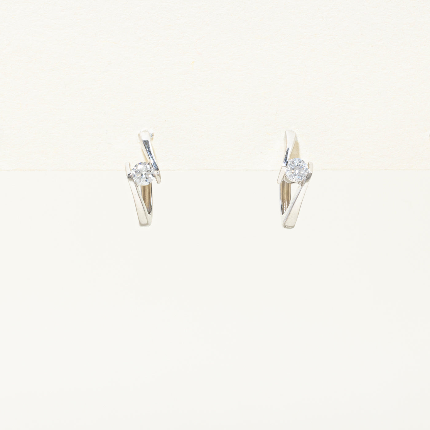 14k Solitaire Diamond Bypass Huggie Earrings | 0.2ctw