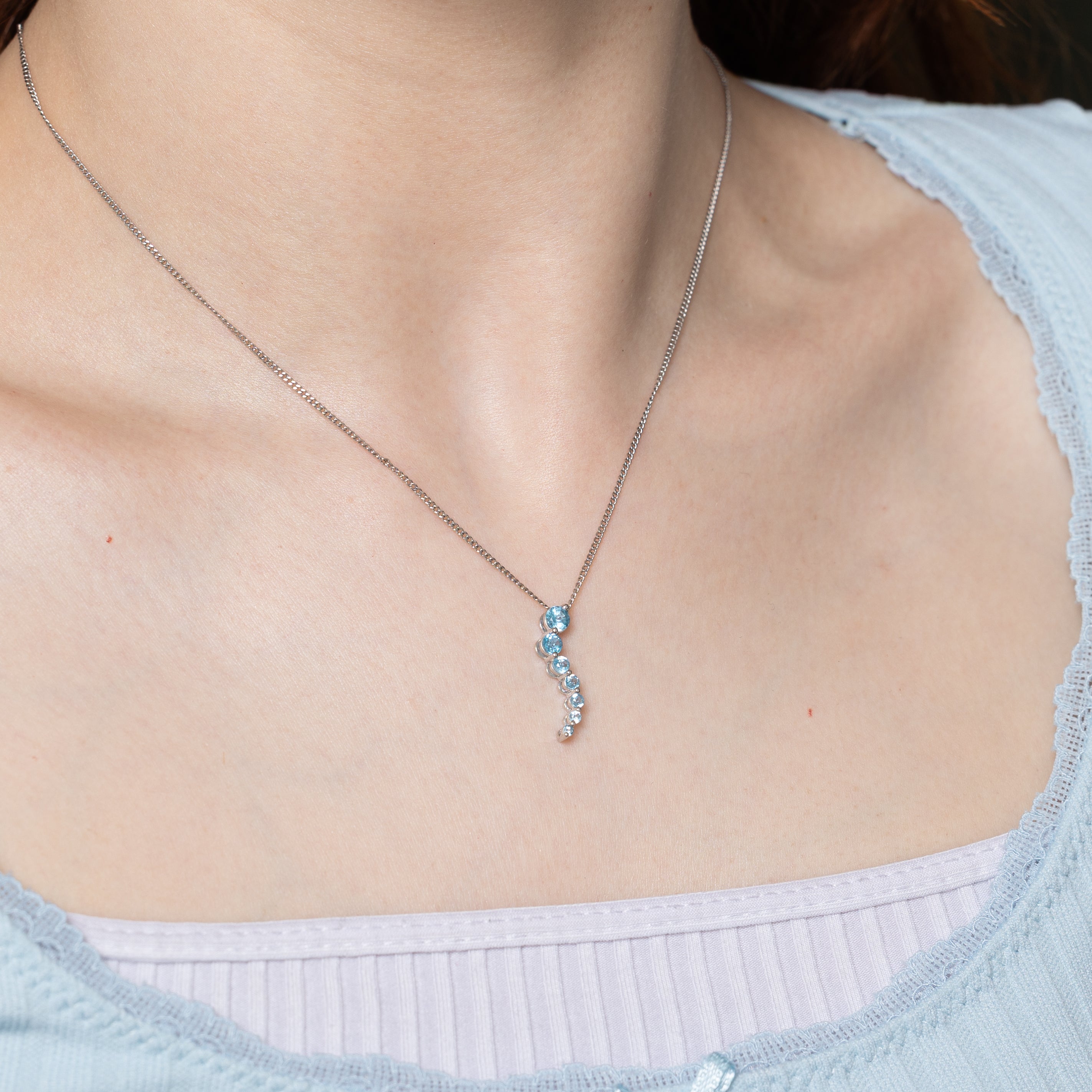 White Gold Blue Topaz Journey Pendant | 0.60ctw
