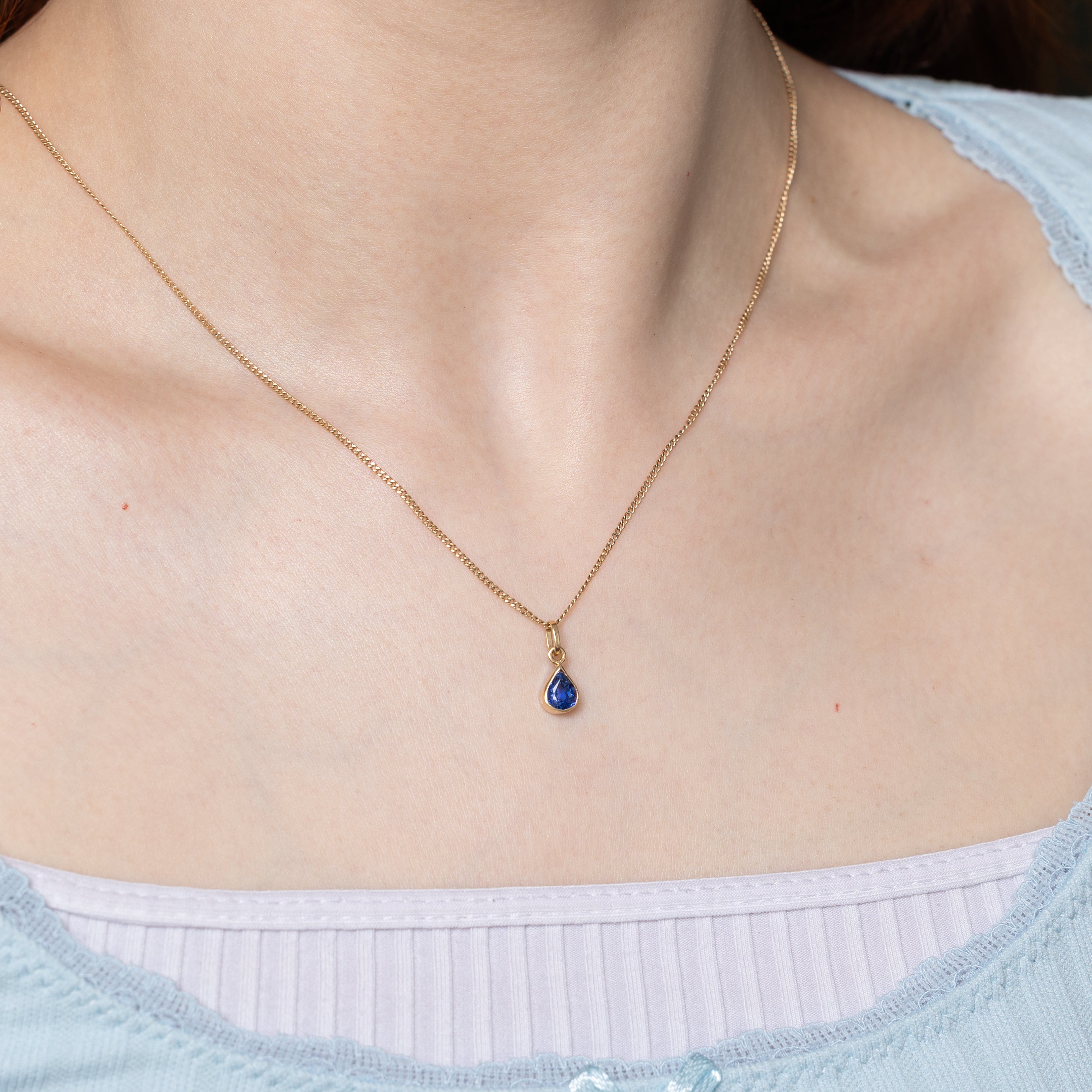 17k Bezel Set Pear Cut Synthetic Sapphire Pendant | 1.35ct