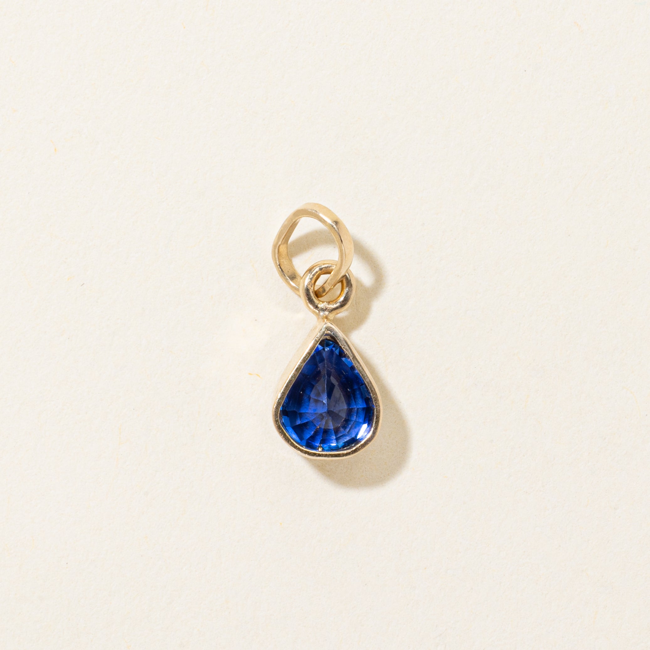 17k Bezel Set Pear Cut Synthetic Sapphire Pendant | 1.35ct