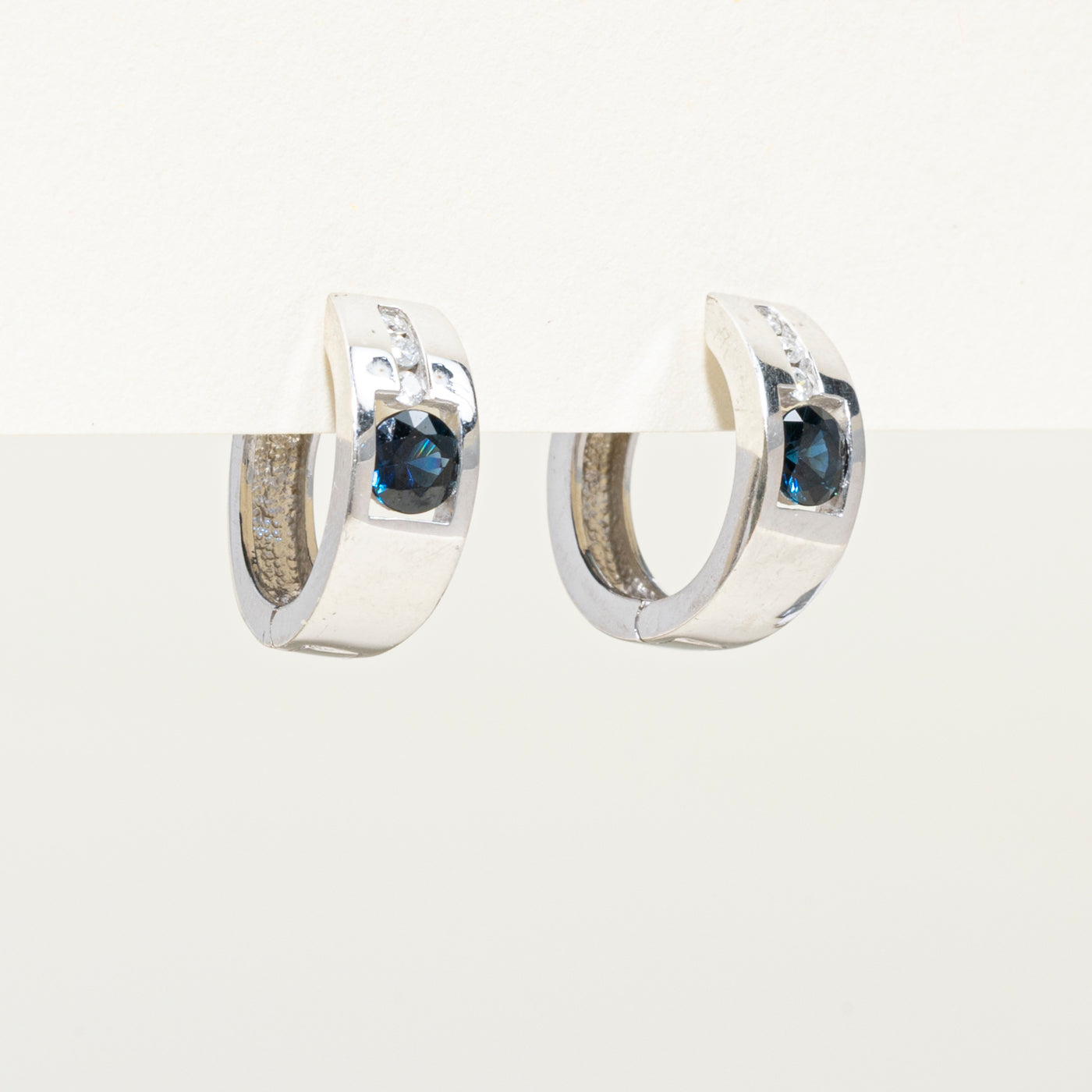 10k White Gold Sapphire & Diamond Huggie Earrings | 0.64ctw, 0.08ct