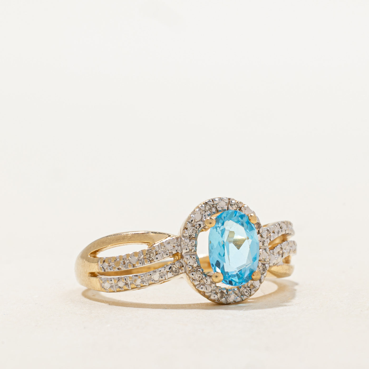 Oval Cut Blue Topaz & Diamond Halo Crossover Ring | 0.73ct, 0.06ctw | SZ 7.25 |