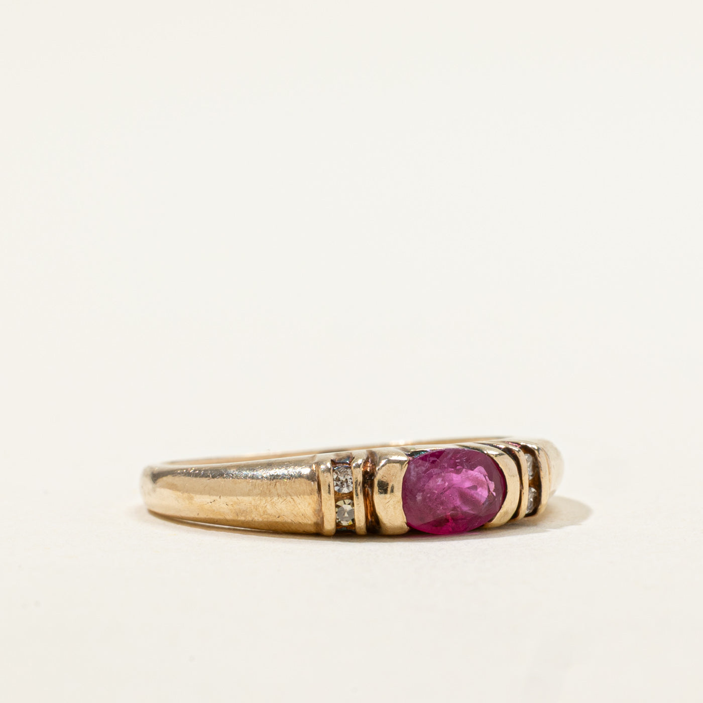 10k East West Oval Cut Ruby & Diamond Accented Ring | 0.50ct, 0.02ctw | SZ 6.75
