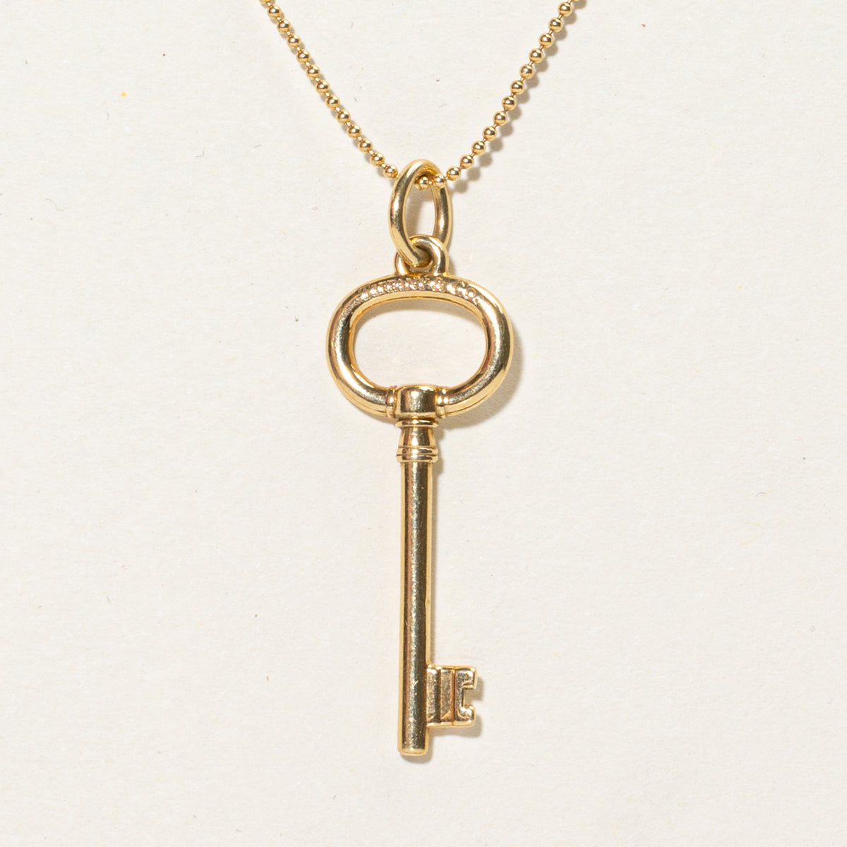 'Tiffany & Co.' Yellow Gold Oval Key Charm Necklace | 24"