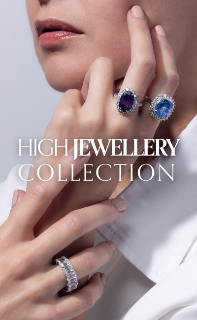 Model wearing three high-jewellery gemstone rings, featuring luxurious gemstones, sapphire and ruby halo designs. Text reads: High Jewellery Collection