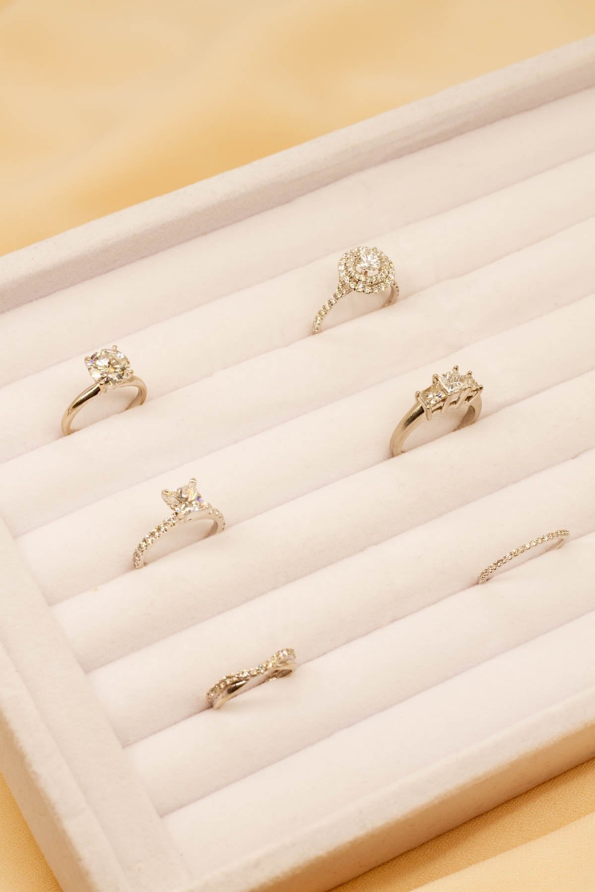 diamond engagement rings in a white velvet tray for customer viewings at the 100 ways showroom in vancouver BC