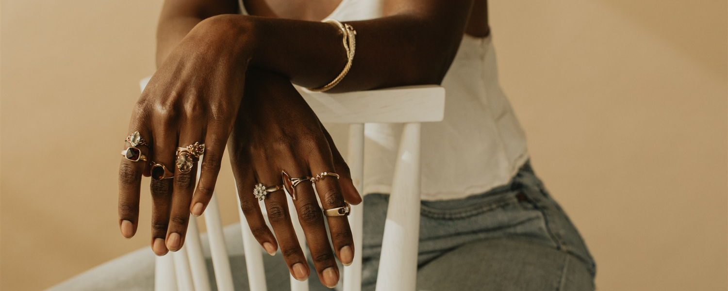 Model wearing assortment of vintage and antique diamond and gemstone rings