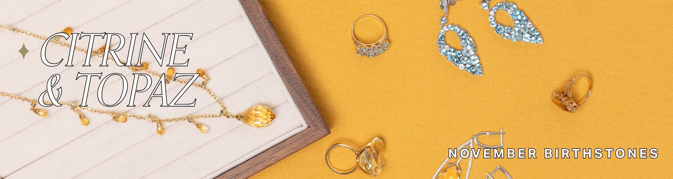 Jewelry with citrine and topaz on a yellow background, text reads: citrine & topaz, november birthstones 