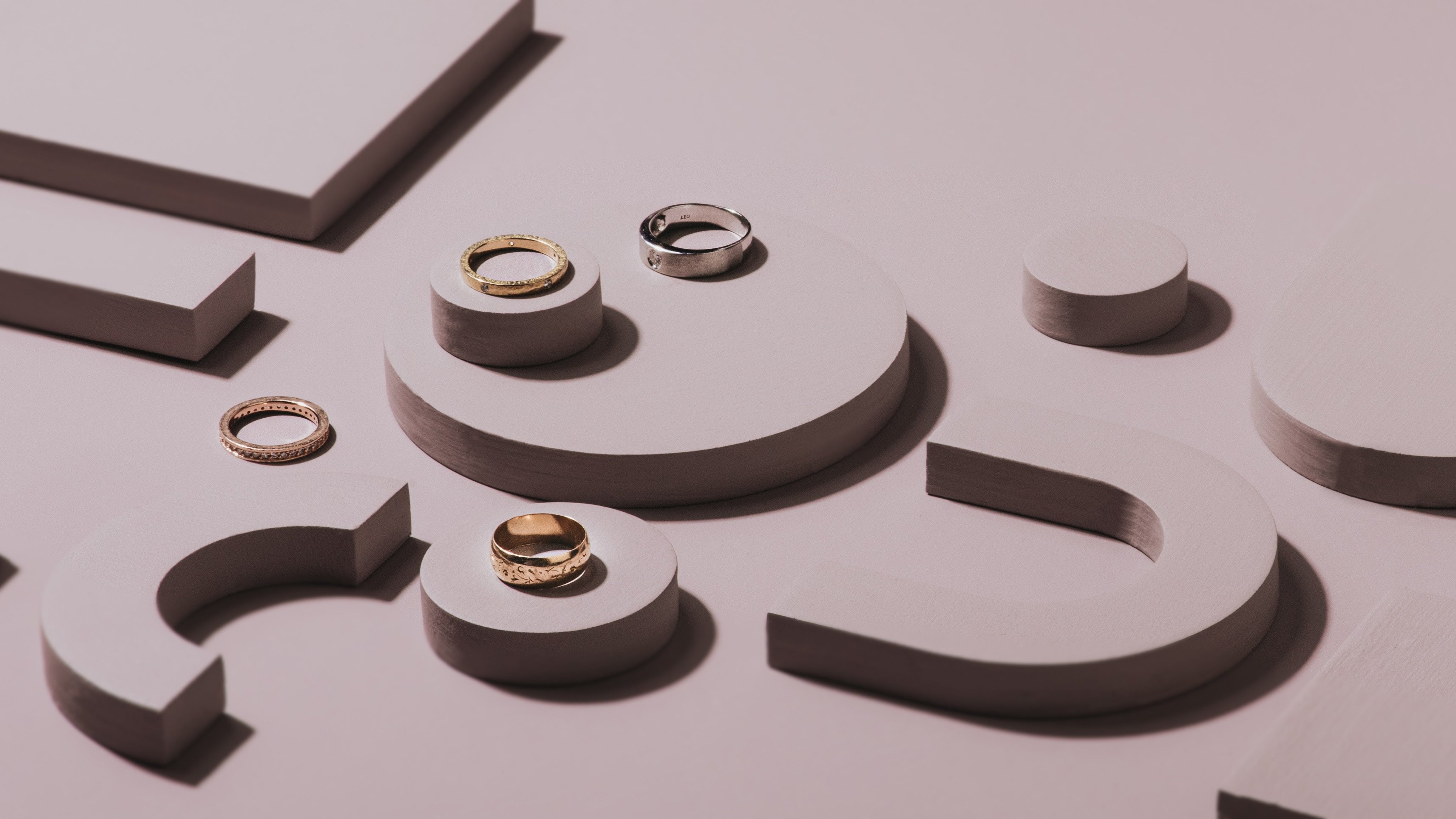 image of wedding bands on arch and circle props in a mauve colour