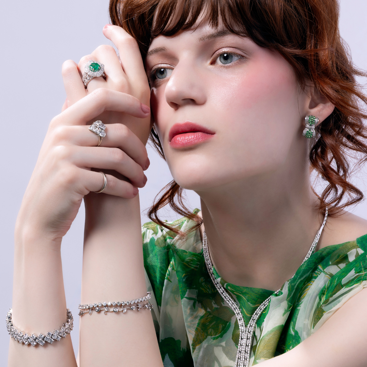 Preloved emerald and diamond jewellery set featuring rings, earrings, bracelet, and statement necklace in a vintage editorial style